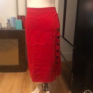 Red pencil skirt with big black buttons going down the left side